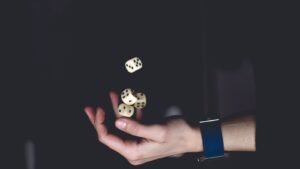 A hand tossing dice, illustrating a random outcome