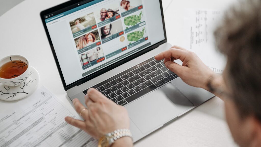 A person browsing a website on a laptop while researching a purchase