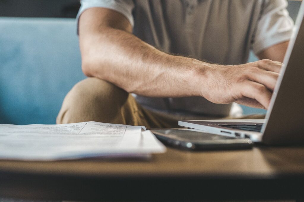 Business owner typing a question about Melbourne SEO agencies into a laptop