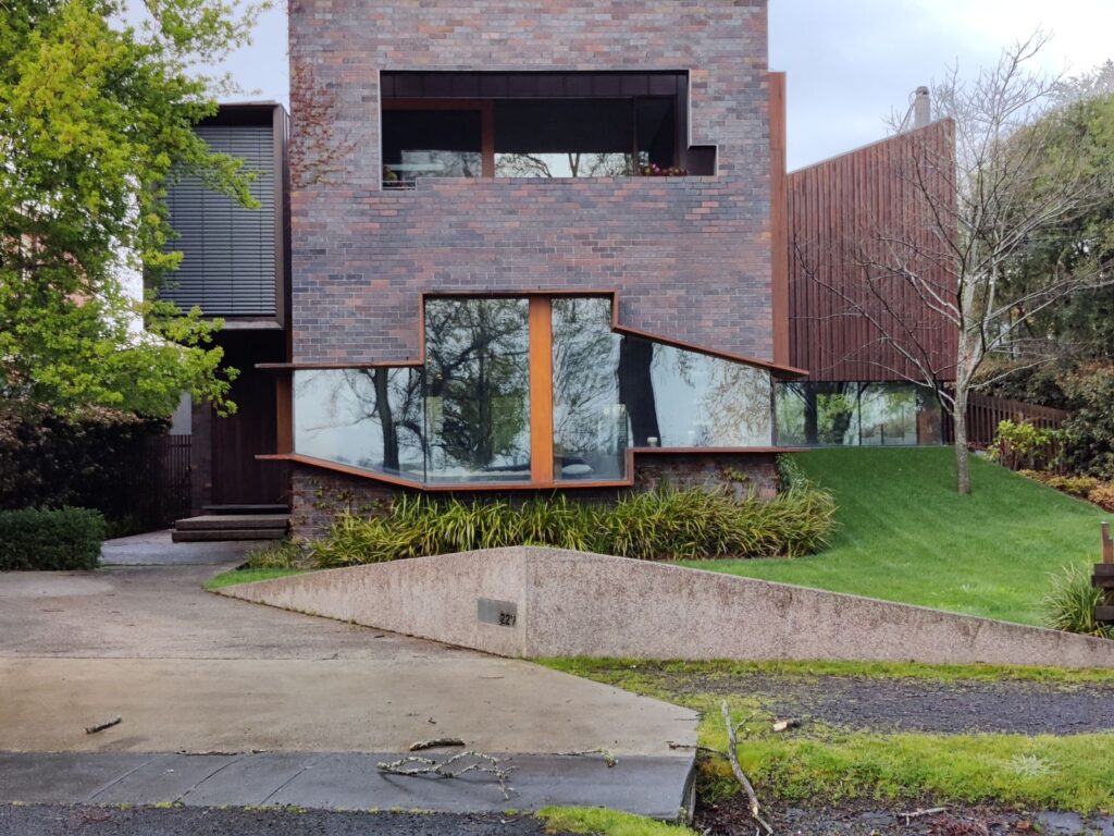 Modern brick custom home with large windows and a sloping lawn in Ballarat, Victoria