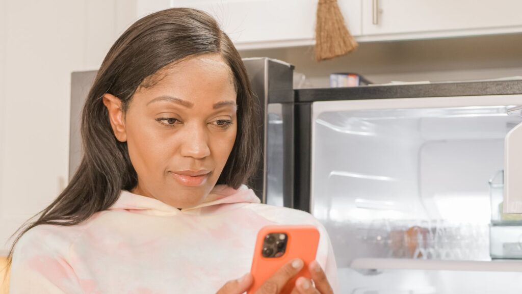 Woman at home reading about a legal question on her phone