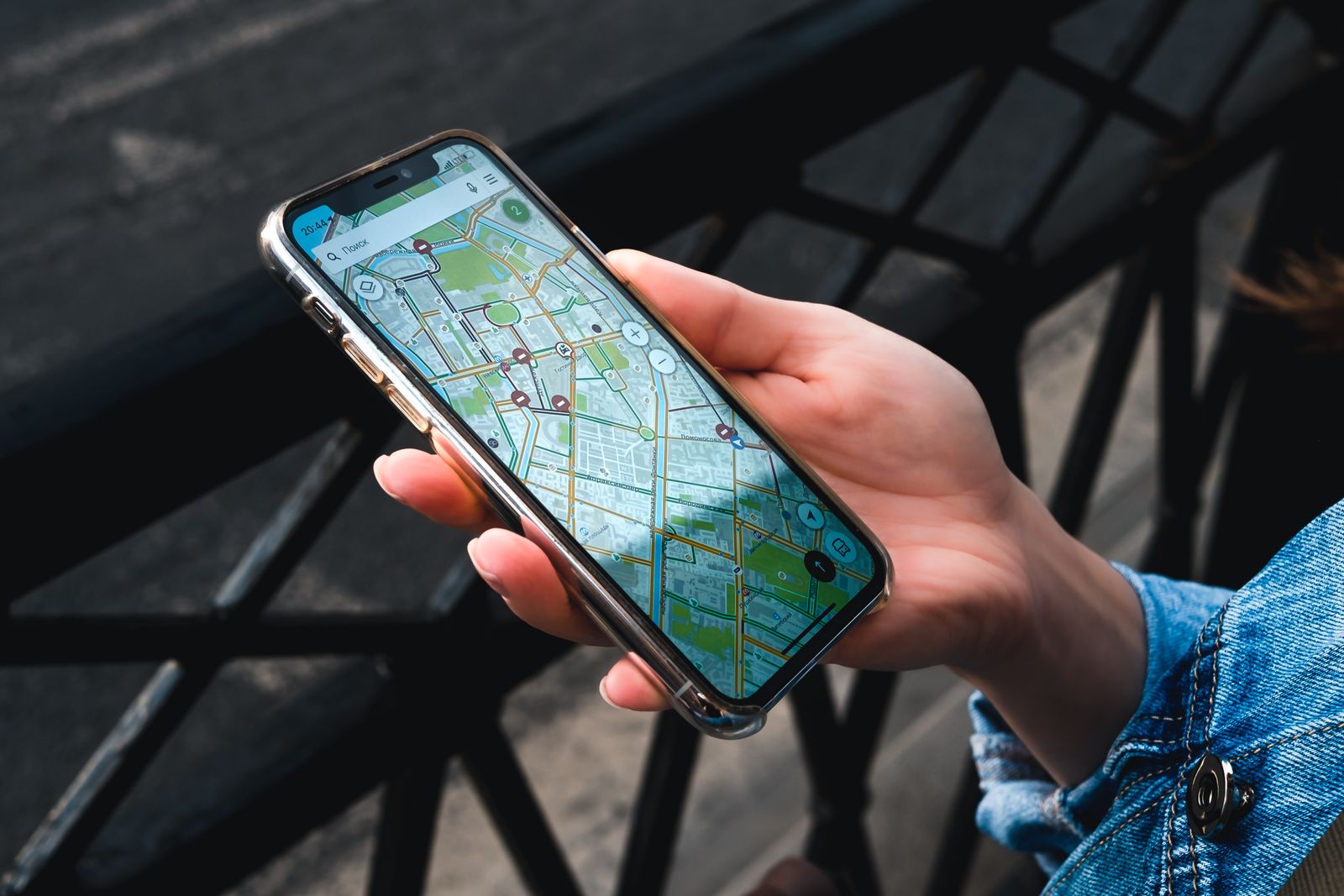Hand holding a smartphone showing a city map, the view where local SEO for lawyers is won