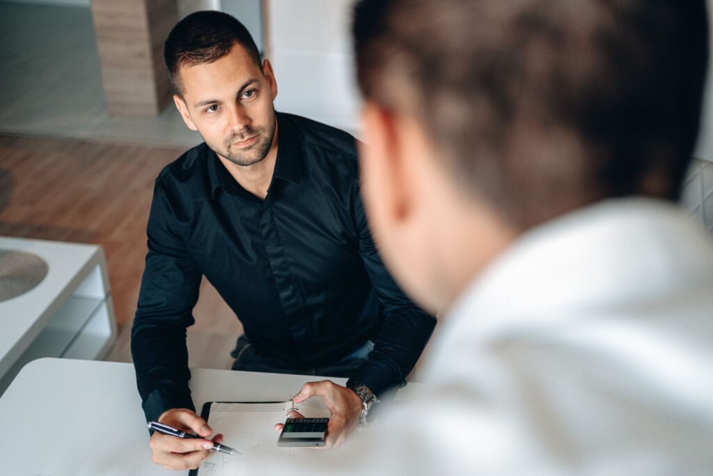 SEO consultant meeting a business owner across a desk to go through a plan